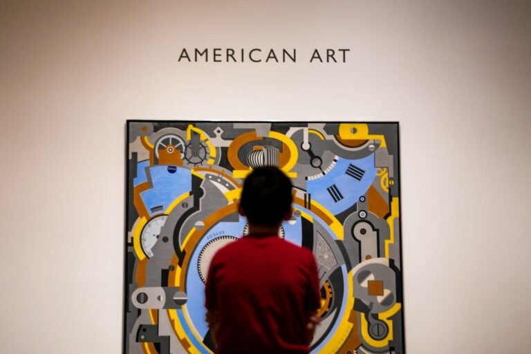 boy in red shirt standing in front of wall with UNK UNK