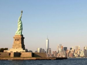 person taking photo of Statue of Liberty